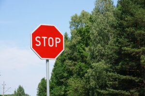 Stop sign trees blue sky